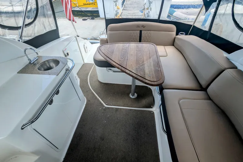 Slide: The Image of 2017 Sea Ray Sundancer 280 interior with seating, table, and sink. - 16