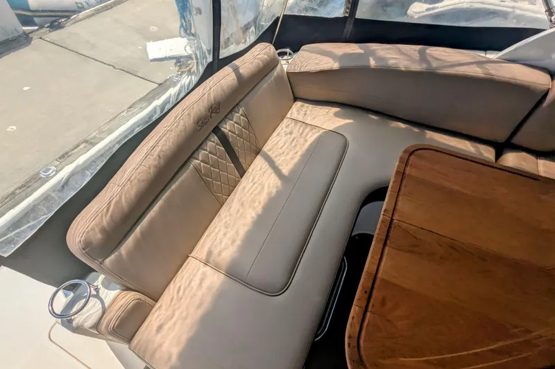 Slide: The Image of Interior of 2017 Sea Ray Sundancer 280 with beige seating and wooden table. - 17