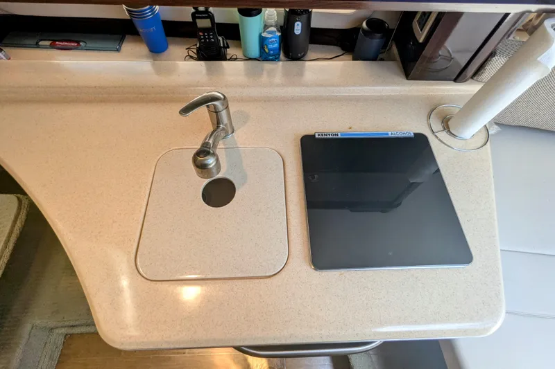 Slide: The Image of 2017 Sea Ray Sundancer 280 galley with sink, stove, and countertop accessories. - 25