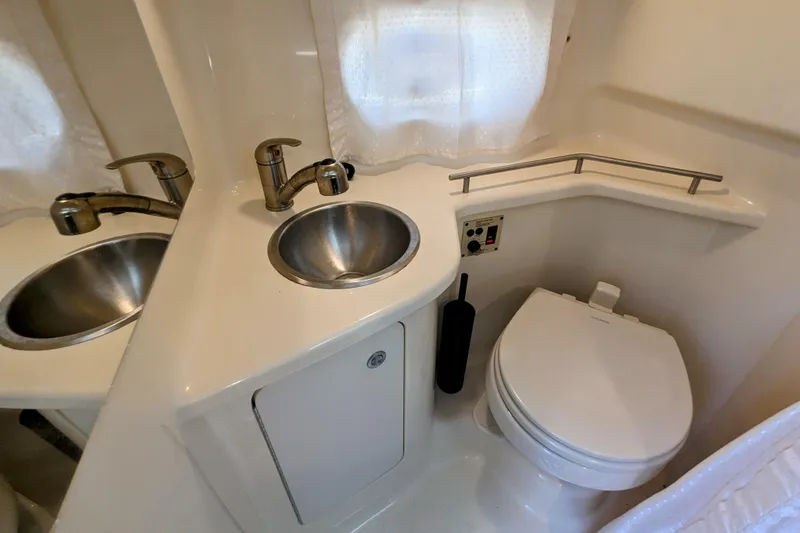 Slide: The Image of Compact bathroom in 2017 Sea Ray Sundancer 280 with sink and toilet. - 28