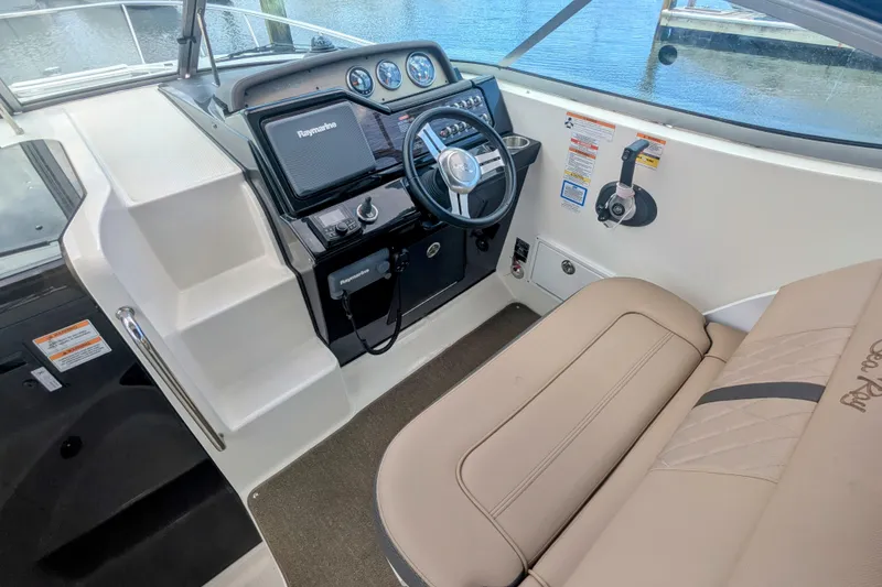 Slide: The Image of 2017 Sea Ray Sundancer 280 helm with steering wheel and navigation system. - 8