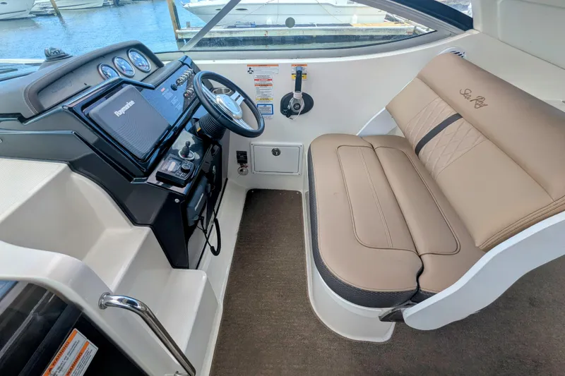 Slide: The Image of 2017 Sea Ray Sundancer 280 helm with tan seating and modern navigation controls. - 9