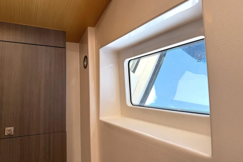 Slide: The Image of Interior view of 2013 Pursuit 365i Sport Coupe, featuring a window and wooden paneling. - 11