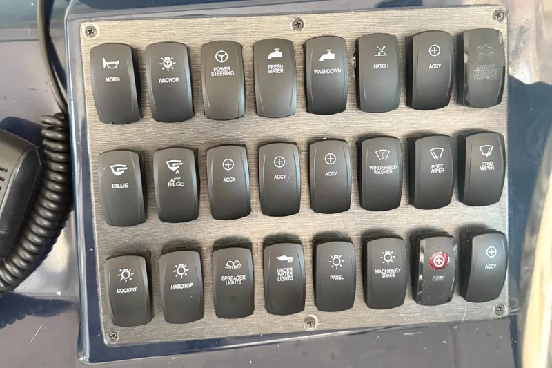 Slide: The Image of Control panel of a 2013 Pursuit 365i Sport Coupe with labeled switches. - 16
