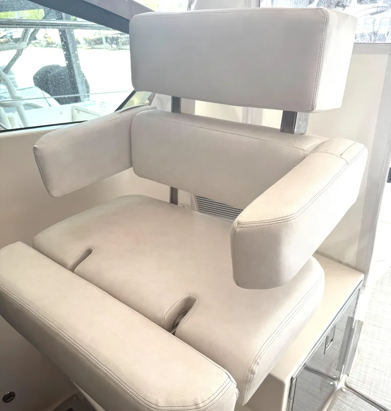 Slide: The Image of Luxury seating on 2013 Pursuit 365i Sport Coupe boat, featuring plush white upholstery. - 18