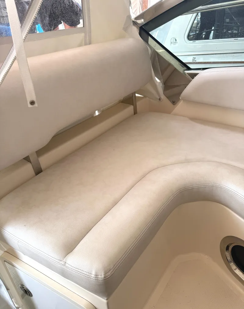 Slide: The Image of 2013 Pursuit 365i Sport Coupe interior with beige cushioned seating. - 19