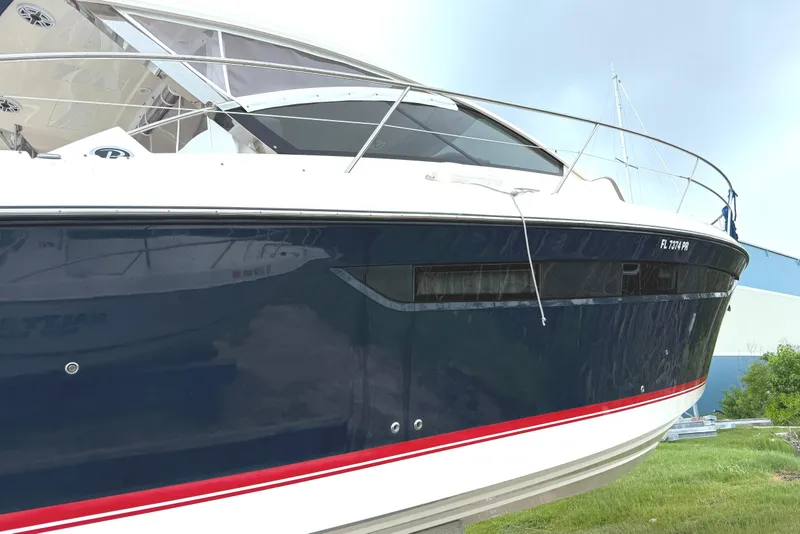 Slide: The Image of 2013 Pursuit 365i Sport Coupe boat with sleek design and blue hull. - 2