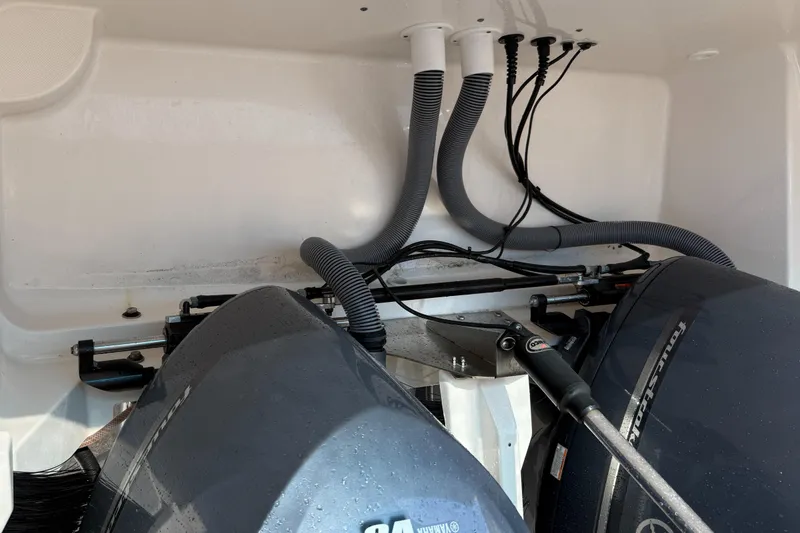 Slide: The Image of Engine compartment of a 2013 Pursuit 365i Sport Coupe with visible wiring and hoses. - 25