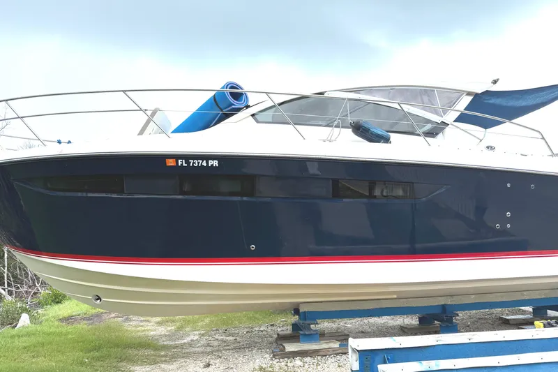 Slide: The Image of 2013 Pursuit 365i Sport Coupe boat on display, featuring sleek design and blue hull. - 4