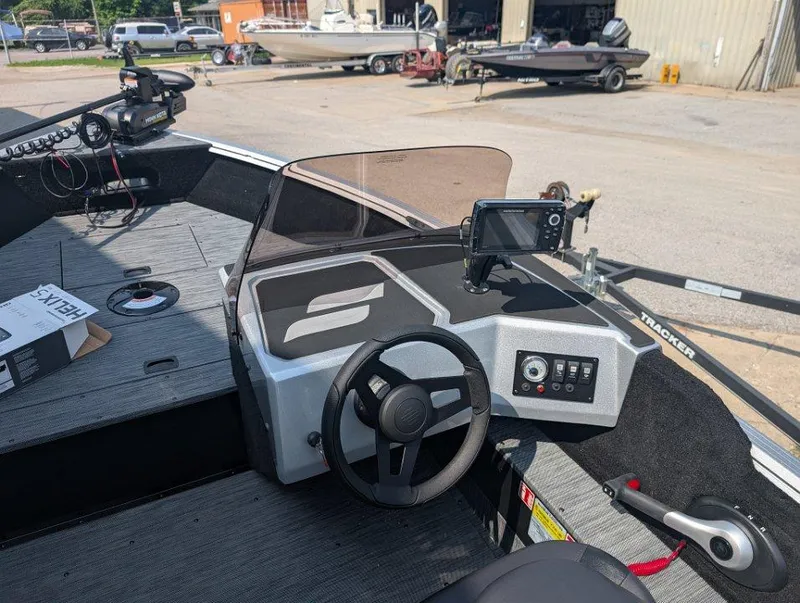 Slide: The Image of 2026 Starcraft 166 Starfish boat interior with steering wheel, control panel, and navigation equipment. - 11