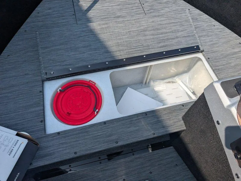 Slide: The Image of 2026 Starcraft 166 Starfish boat interior with storage compartment and red hatch cover. - 6