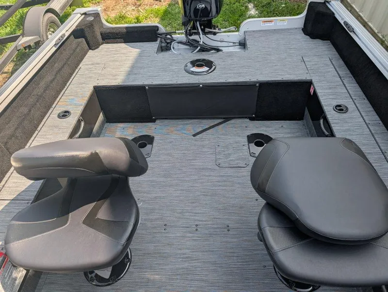 Slide: The Image of 2026 Starcraft 166 Starfish boat interior with two seats and motor, gray flooring. - 8