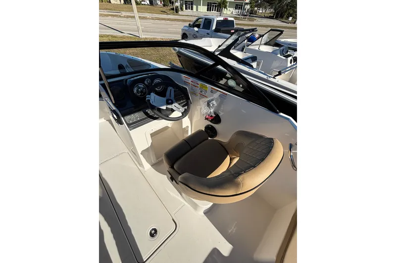 Slide: The Image of 2025 Bayliner VR4 Bowrider OB interior with tan seating and open deck layout. - 10