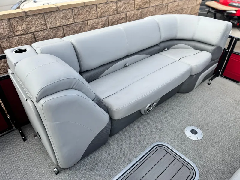 Slide: The Image of 2023 Regency 250 DL3 boat interior with gray cushioned seating and cup holder. - 10