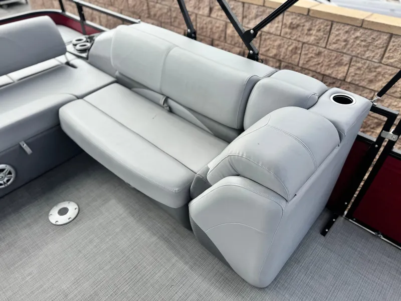 Slide: The Image of 2023 Regency 250 DL3 boat interior with gray seating and cup holders. - 14