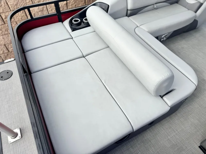 Slide: The Image of 2023 Regency 250 DL3 boat interior with gray cushioned seating and cup holders. - 16