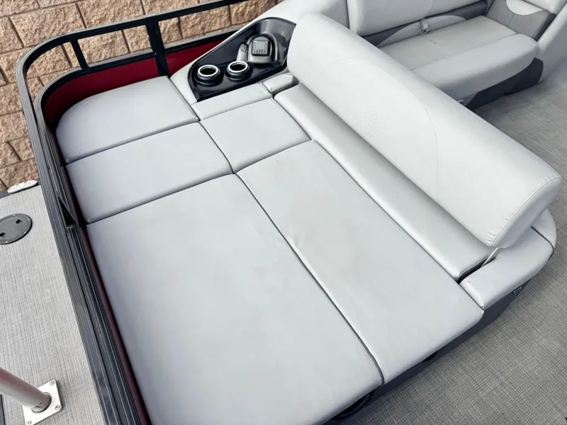 Slide: The Image of 2023 Regency 250 DL3 boat interior with gray cushioned seating and cup holders. - 17