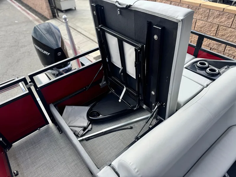 Slide: The Image of 2023 Regency 250 DL3 boat interior with Mercury engine, featuring foldable seating and cup holders. - 18