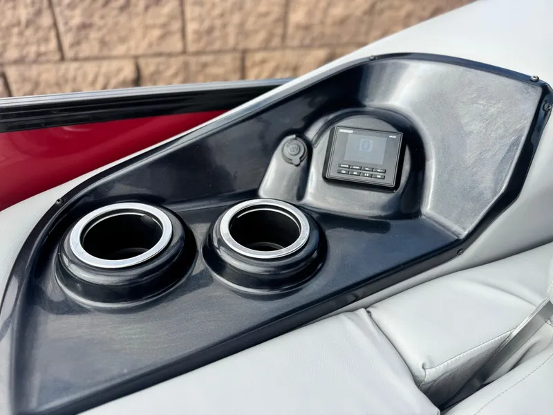 Slide: The Image of 2023 Regency 250 DL3 boat console with cup holders and control panel. - 19