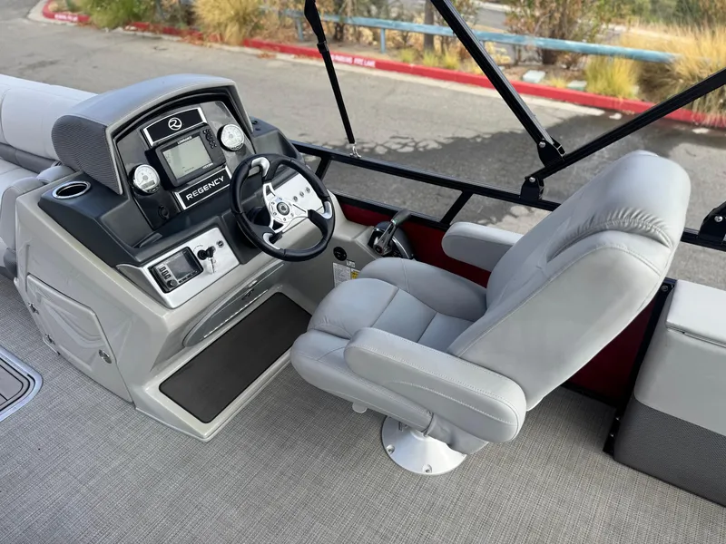 Slide: The Image of 2023 Regency 250 DL3 boat helm with steering wheel and captain's chair. - 21