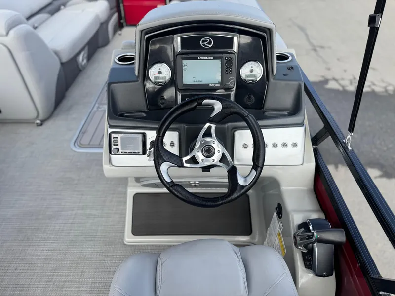 Slide: The Image of 2023 Regency 250 DL3 boat dashboard with steering wheel and navigation controls. - 22