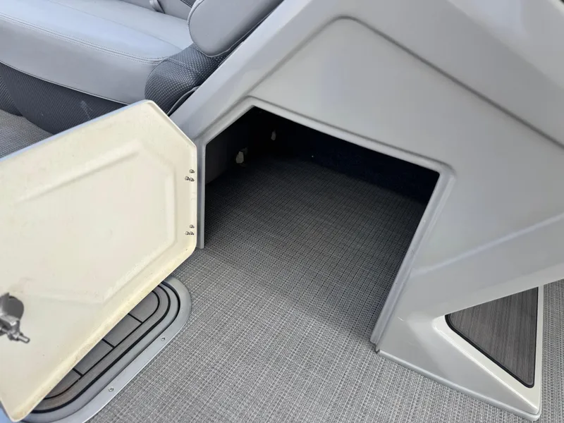 Slide: The Image of Open storage compartment on 2023 Regency 250 DL3 boat with gray interior. - 26