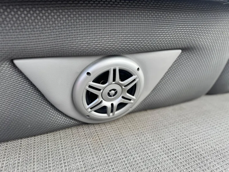 Slide: The Image of Speaker detail in 2023 Regency 250 DL3 boat interior, featuring textured upholstery. - 27