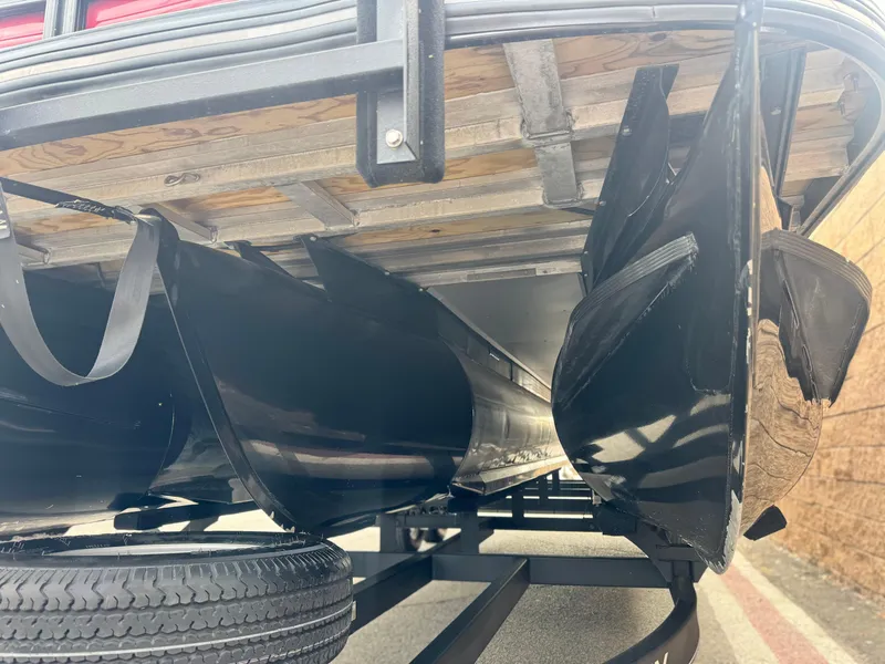 Slide: The Image of Underside view of 2023 Regency 250 DL3 pontoon boat, showcasing pontoons and trailer. - 4