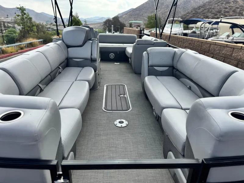 Slide: The Image of 2023 Regency 250 DL3 pontoon boat with spacious seating and modern design. - 8