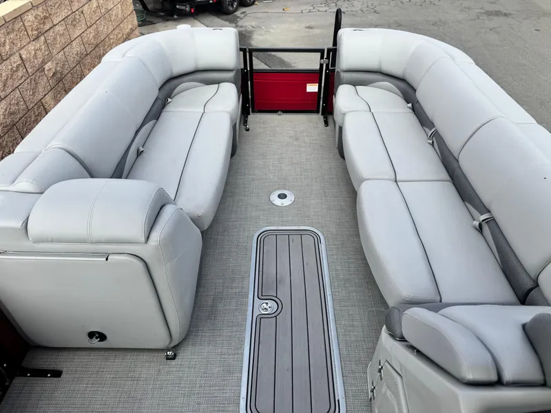 Slide: The Image of 2023 Regency 250 DL3 pontoon boat interior with gray seating and flooring. - 9
