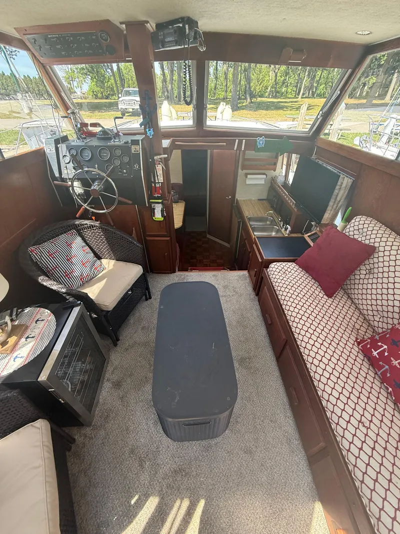 Slide: The Image of Interior of a 1985 Marinette 32 Sedan boat with cozy seating and helm. - 16