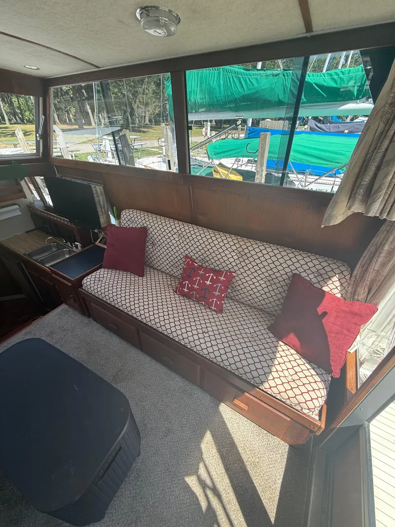 Slide: The Image of Interior of 1985 Marinette 32 Sedan with patterned sofa and red cushions. - 17
