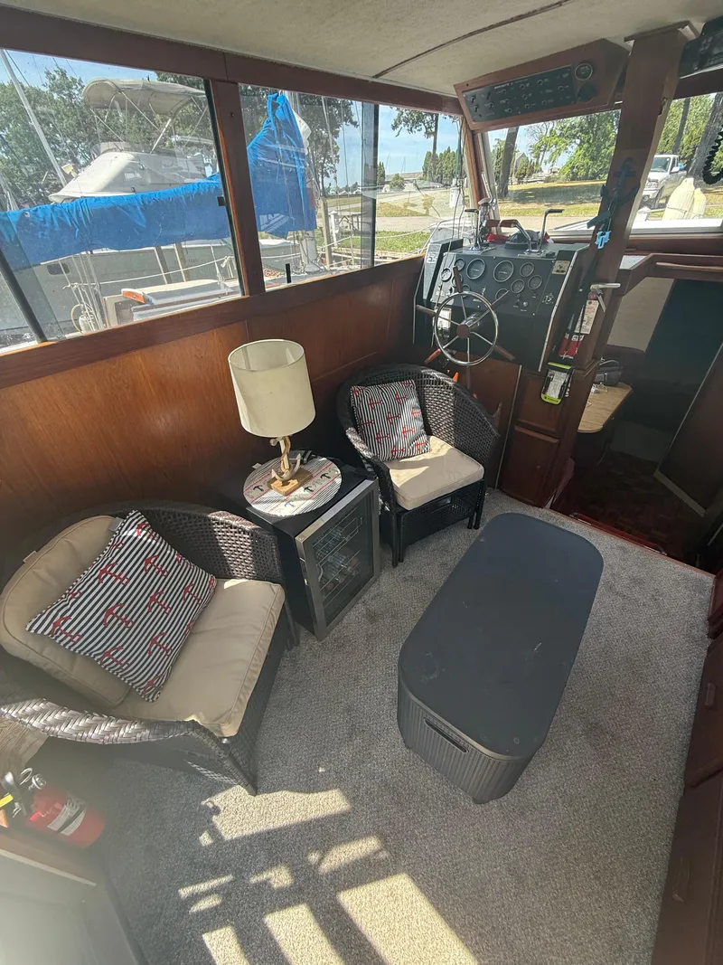Slide: The Image of Interior of 1985 Marinette 32 Sedan with cozy seating and helm station. - 18