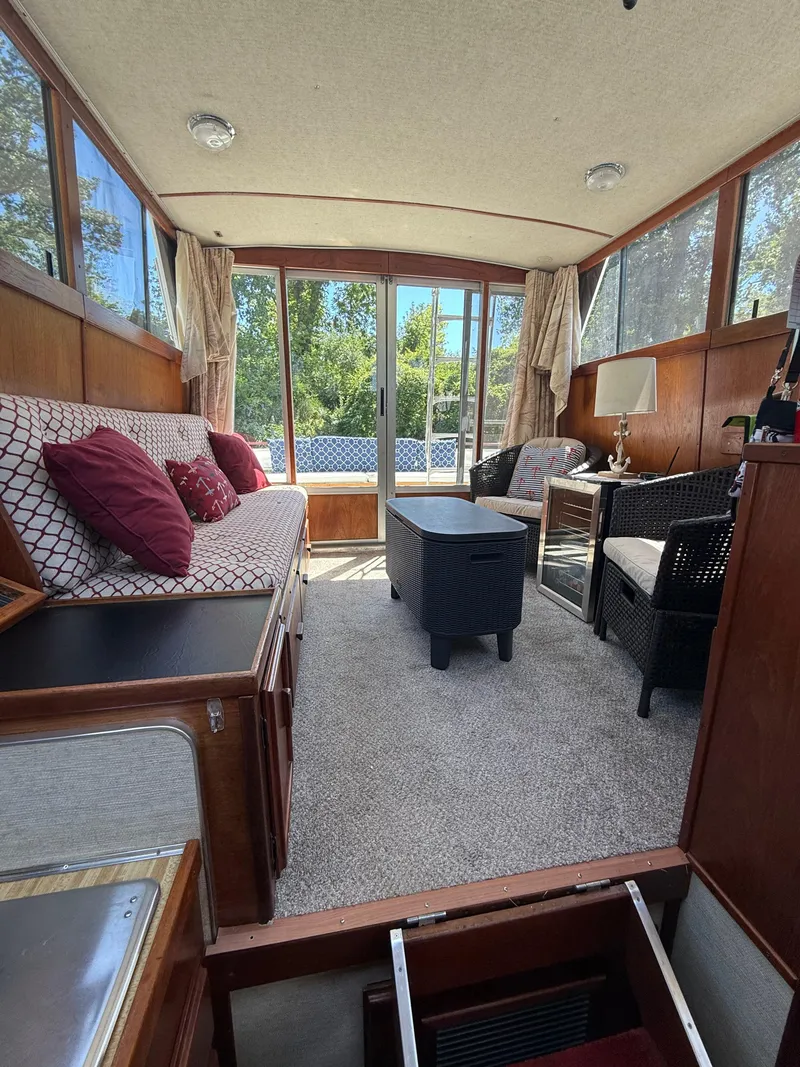 Slide: The Image of Interior of 1985 Marinette 32 Sedan with cozy seating, carpet, and natural light. - 20