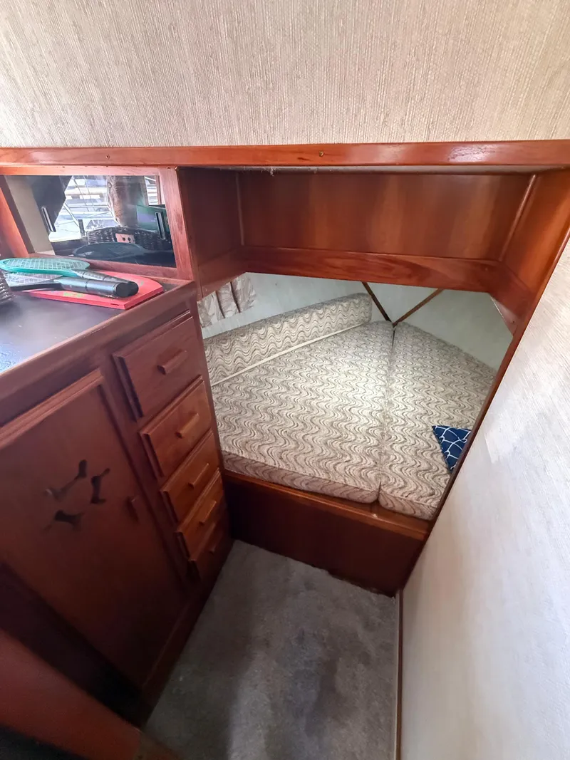Slide: The Image of Interior of 1985 Marinette 32 Sedan with cozy cabin and wooden cabinetry. - 24