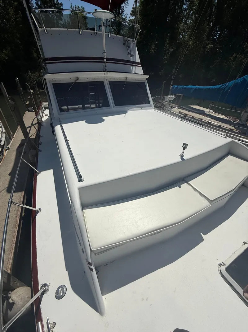 Slide: The Image of 1985 Marinette 32 Sedan boat with spacious deck and seating area. - 4