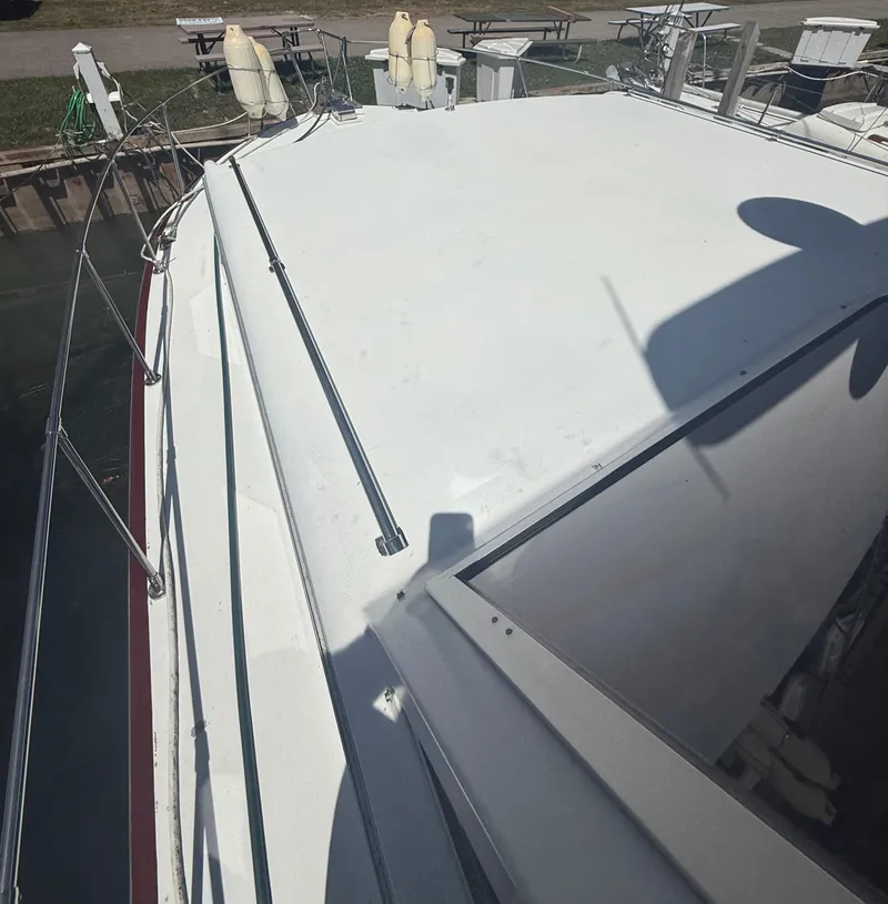 Slide: The Image of 1985 Marinette 32 Sedan boat deck with railing and dockside view. - 9