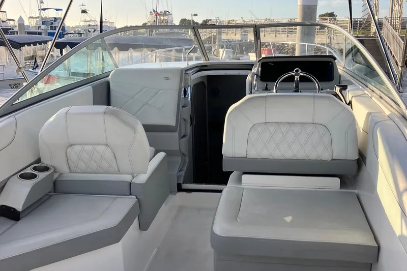 Slide: The Image of 2023 Regal 26 XO boat interior with luxurious seating and steering wheel. - 11