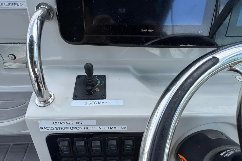 Slide: The Image of 2023 Regal 26 XO boat dashboard with Garmin display and joystick controls. - 14