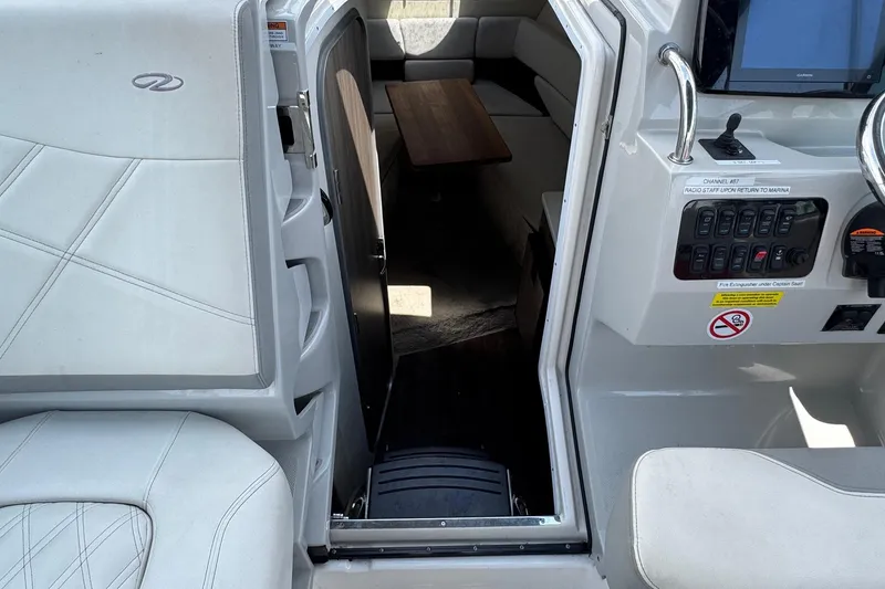 Slide: The Image of 2023 Regal 26 XO boat interior with seating and control panel. - 15
