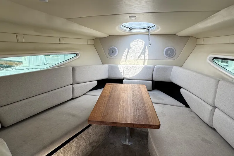 Slide: The Image of Interior of 2023 Regal 26 XO boat with cozy seating and wooden table. - 16