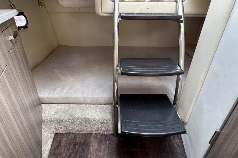 Slide: The Image of Interior cabin of 2023 Regal 26 XO boat with ladder and sleeping area. - 17