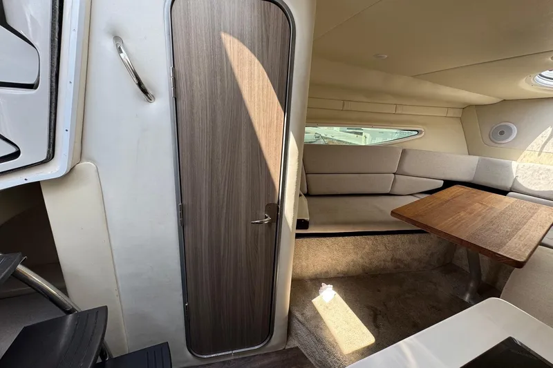 Slide: The Image of 2023 Regal 26 XO cabin interior with seating and wooden table. - 18