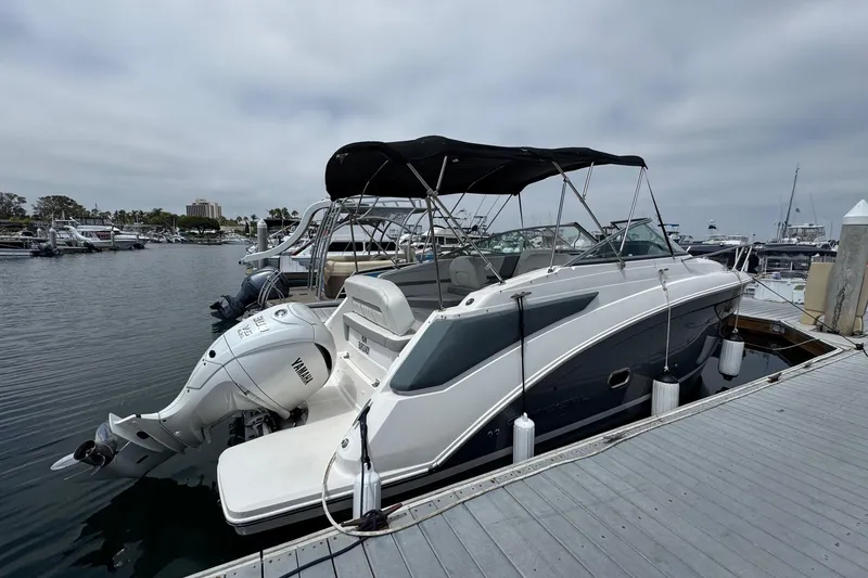 Slide: The Image of 2023 Regal 26 XO boat docked with Yamaha outboard motor, marina background. - 2