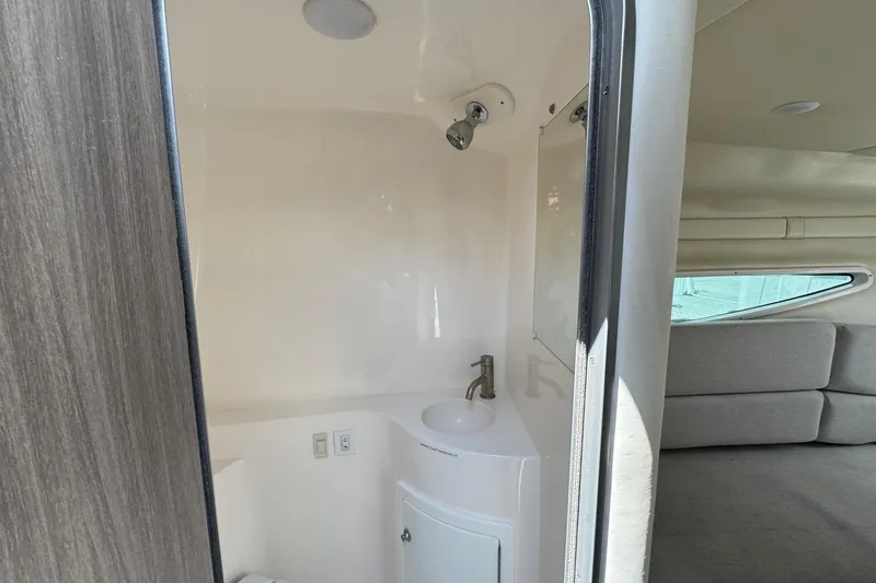 Slide: The Image of 2023 Regal 26 XO boat interior with compact bathroom and seating area. - 20