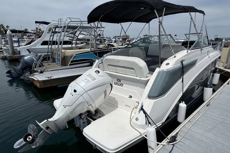 Slide: The Image of 2023 Regal 26 XO boat docked, featuring a powerful outboard motor and sleek design. - 4