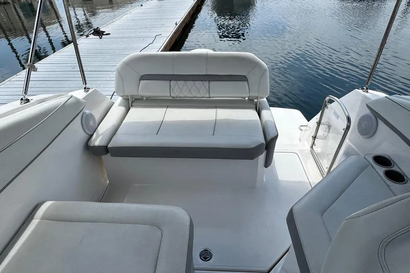 Slide: The Image of 2023 Regal 26 XO boat interior with comfortable seating and waterfront view. - 7