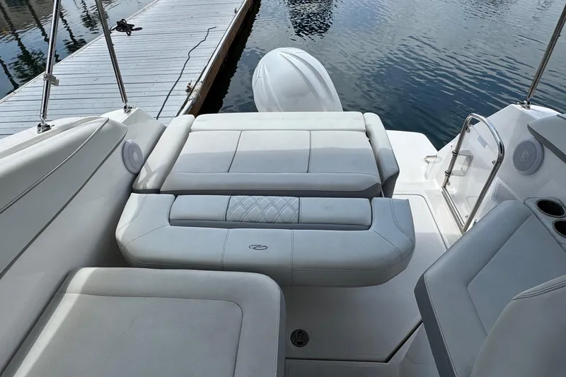 Slide: The Image of 2023 Regal 26 XO boat interior with white seating and dock view. - 8
