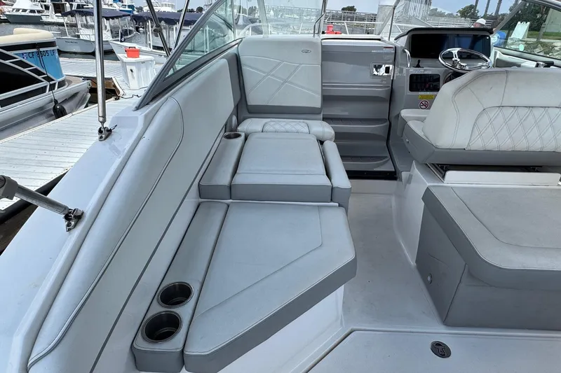 Slide: The Image of 2023 Regal 26 XO boat interior with plush seating and modern dashboard. - 9