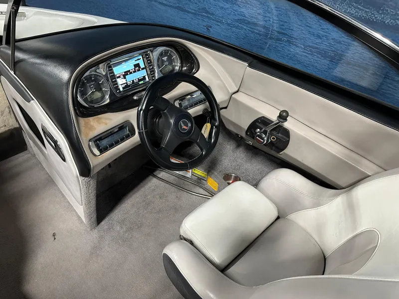 Slide: The Image of 2010 Malibu Wakesetter 247 LSV boat interior with steering wheel and dashboard controls. - 10